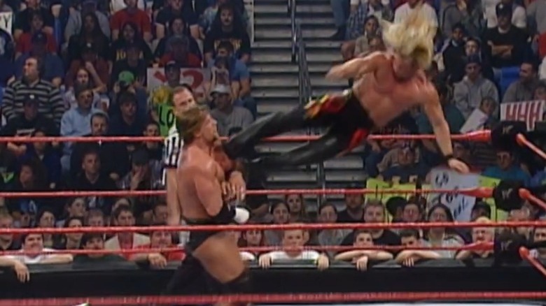 Chris Jericho dropkicking HHH