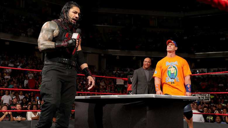 Roman Reigns cuts a promo on John Cena during a contract signing for a match on "WWE Raw."