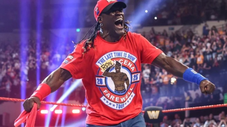 R-Truth poses in the ring in his "Ron Cena" shirt, a parody of John Cena's retirement shirt, on an episode of WWE programming.