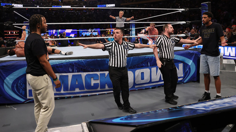 Jalen Brunson and Tyrese Haliburton face off on "WWE SmackDown" and are separated by referees on the outside of the ring.