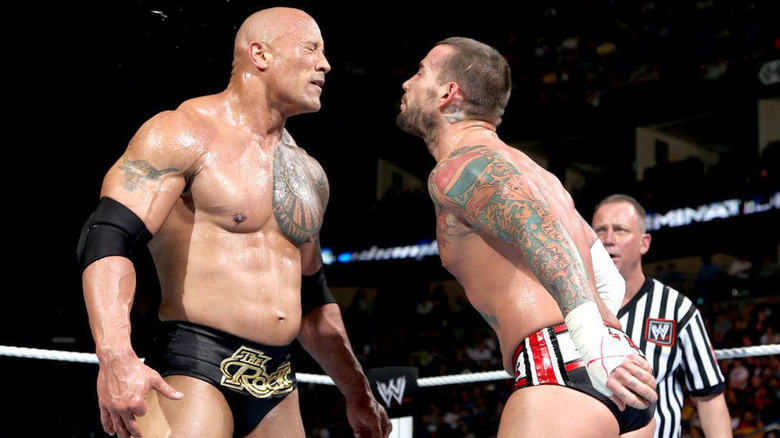 The Rock and CM Punk In Ring 