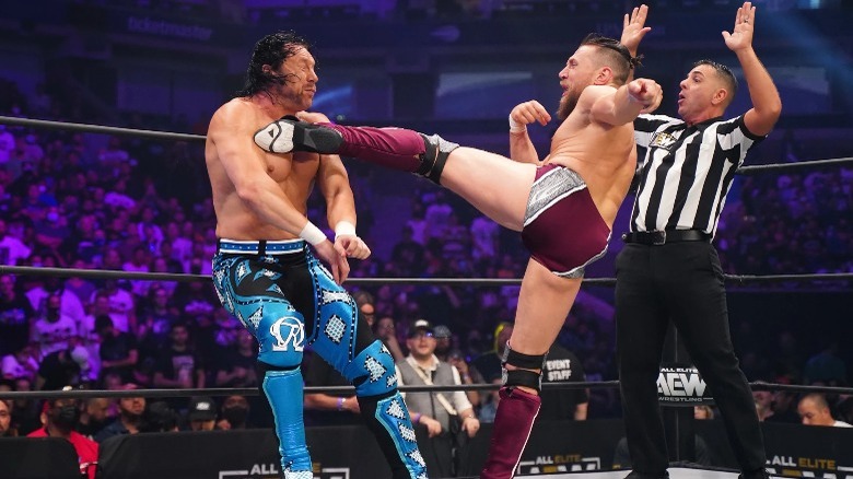 Bryan Danielson kicking Kenny Omega