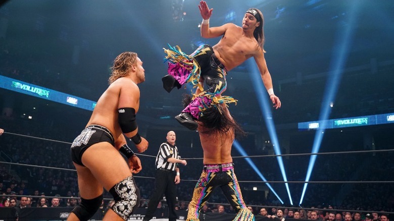 Young Bucks dropkicking Adam Page