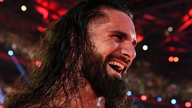 Seth Rollins laughs during a WWE match