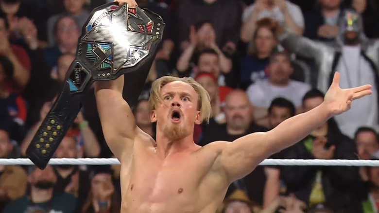 NXT Champion Ilja Dragunov holds his title high