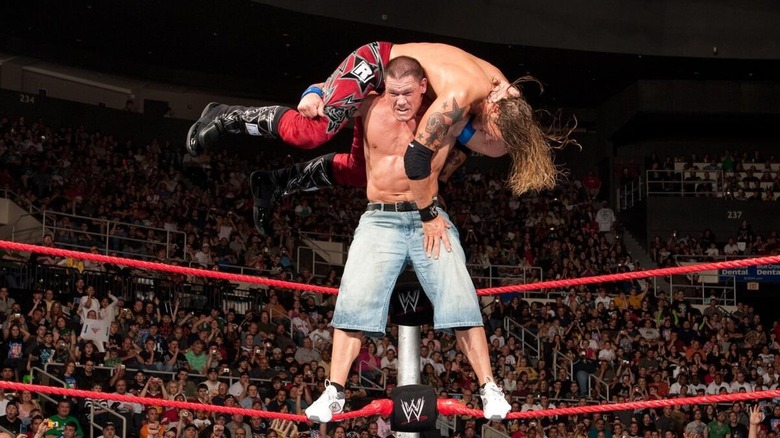 John Cena with Edge on his shoulders