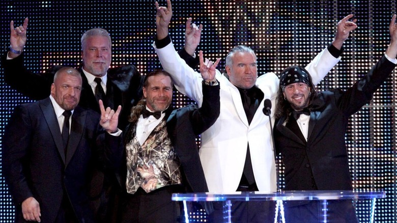 Triple H, Kevin Nash, Scott Hall, and X-Pac, the group known as "The Kliq" poses on stage during their WWE Hall of Fame Induction.