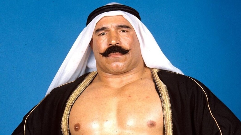 The Iron Sheik poses in his gear for a backstage photoshoot.