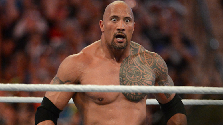 The Rock standing in the ring