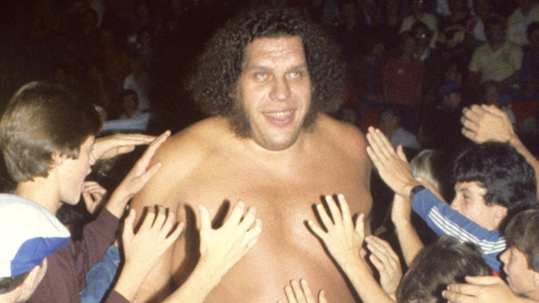 Andre the Giant walking through a crowd of fans