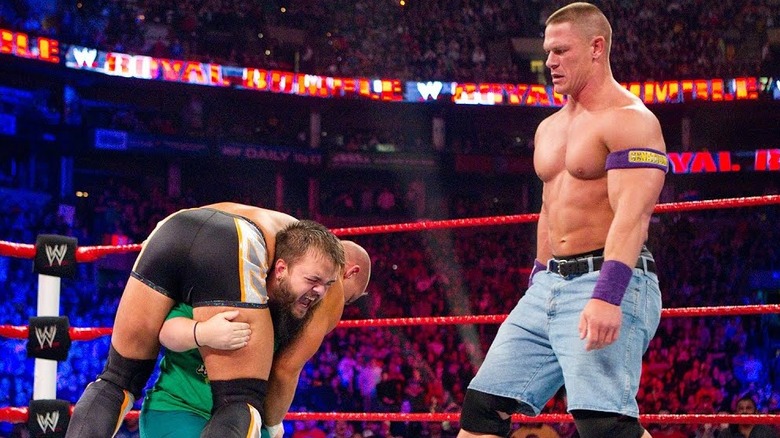 John Cena looks on as Hornswoggle has another WWE Superstar up on his shoulders