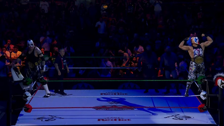Pagano & Psycho Clown in the ring with the War Raiders