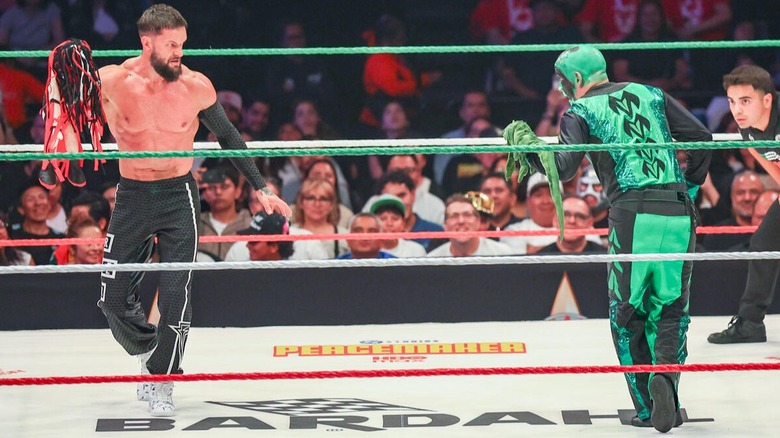 Finn Balor, with Demonito, square off with Mr. Iguana and La Yesca during their previous clash at TripleMania XXXIII