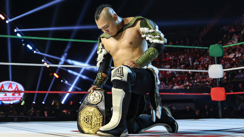 El Hijo del Vikingo takes a moment with his AAA Mega Championship before defending it on the first WWE Worlds Collide with AAA-WWE