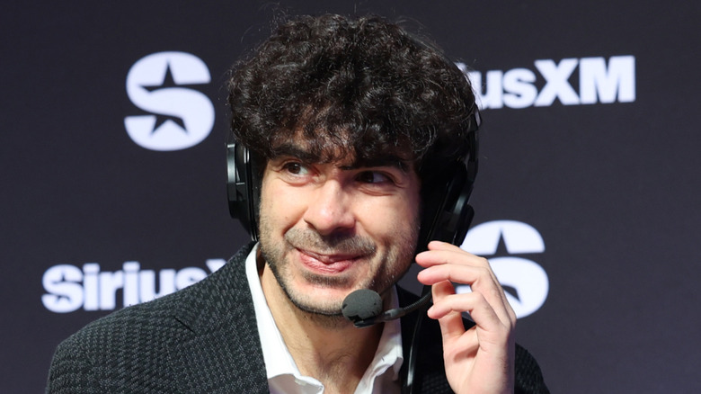 Tony Khan making sure his headset is on straight