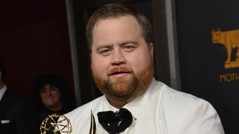 Paul Walter Hauser holding Emmy
