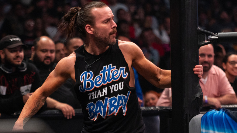 Adam Cole runs around ringside