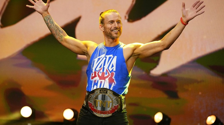 Adam Cole stands on the stage of 