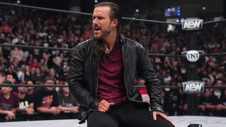 Adam Cole on his knees looking shocked