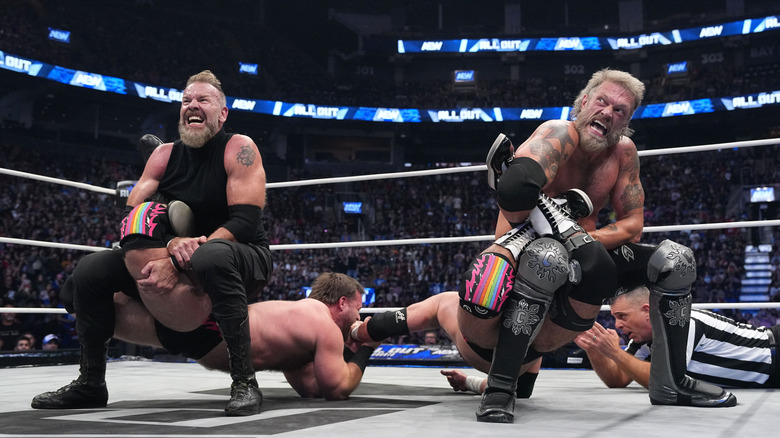 Adam Copeland and Christian Cage putting FTR in submission holds