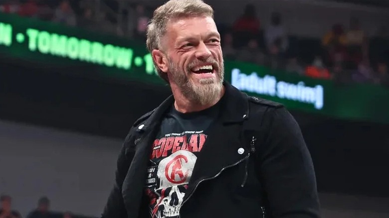 Adam Copeland smiling during a promo segment on an AEW show.