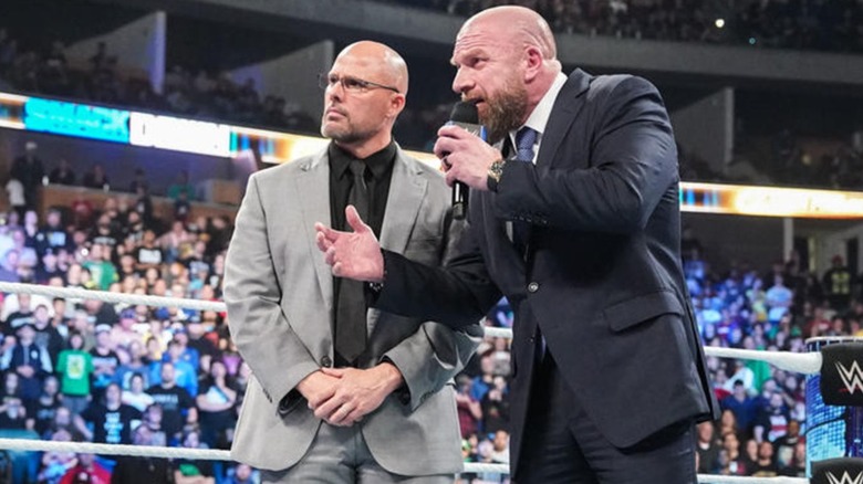 Adam Pearce Looks On As Triple H Speaks