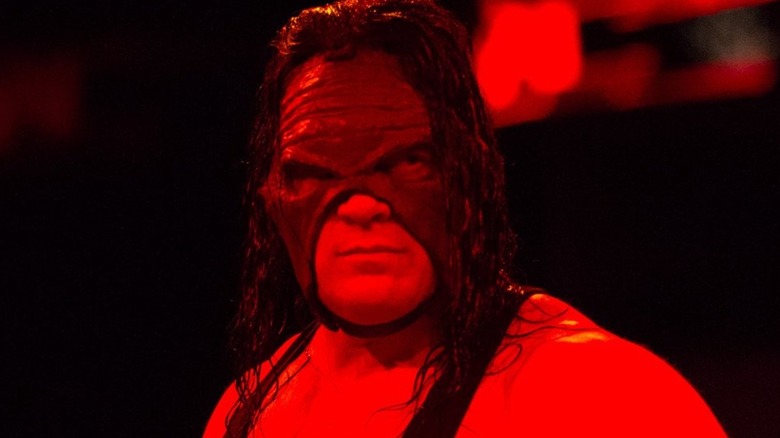 Kane stands emotionless