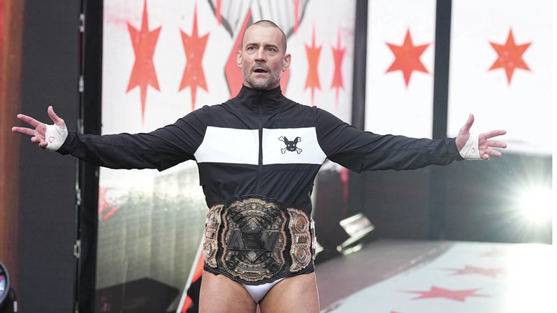 CM posing with title belt