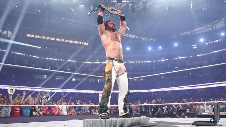 Hangman Page celebrates with the AEW World Title