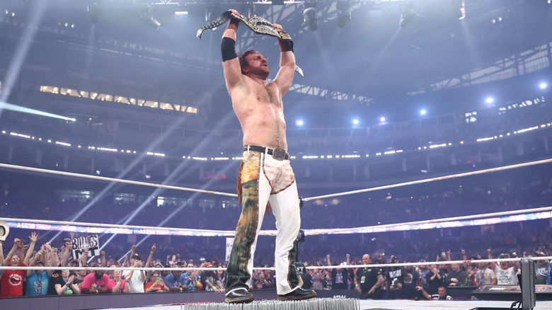 "Hangman" Adam Page celebrates with the AEW World title