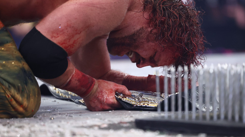 Adam Page clutches the AEW world title at All In