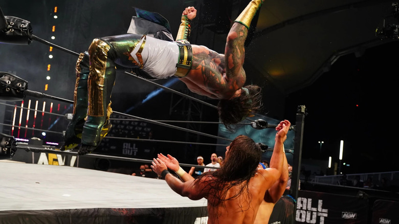 Luchasaurus leaping off the apron with a moonsault