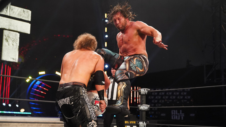 Kenny Omega hitting Adam Page with a V-Trigger
