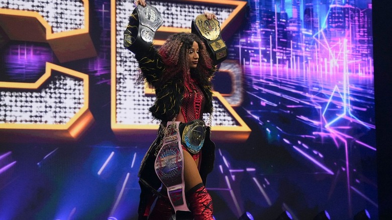 Mercedes Moné posing with her titles