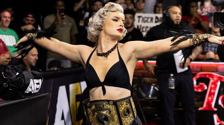 "Timeless" Toni Storm poses with the AEW Women's World Championship around her waist during a women's bout in the ring on "AEW Collision."