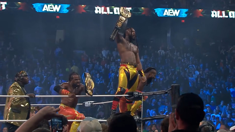 Swerve Strickland and New Level celebrate with the Trios titles