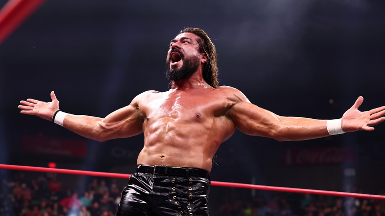 AEW National Champion Andrade El Idolo poses in the ring and yells to the crowd during a match on AEW programming.