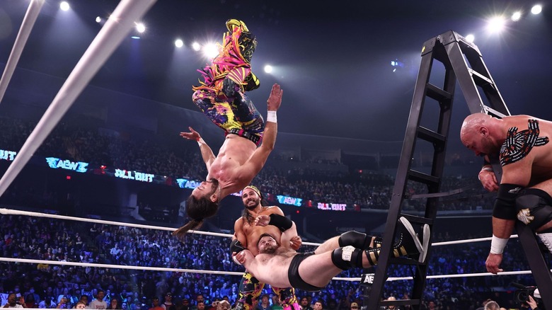 Nick Jackson flips onto Cash Wheeler, as Dax Harwood and Matt Jackson look on