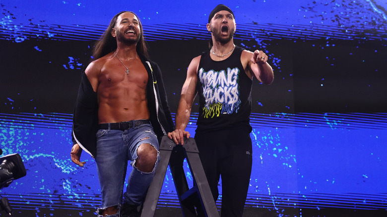 Matt and Nick Jackson, the Young Bucks, stand atop and ladder and gesture toward their AEW All Out ladder match opponents in the ring during the September 23, 2026 edition of "AEW Dynamite."