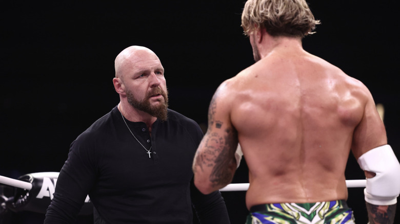 Moxley and Ospreay staring down one another in the ring