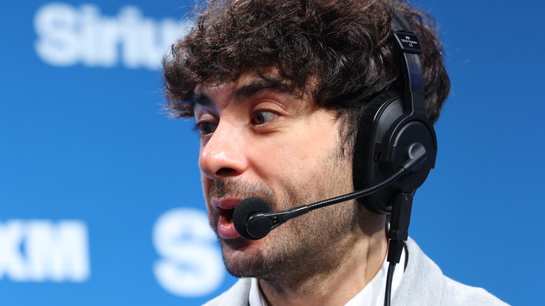 Close-up of Tony Khan wearing a headset