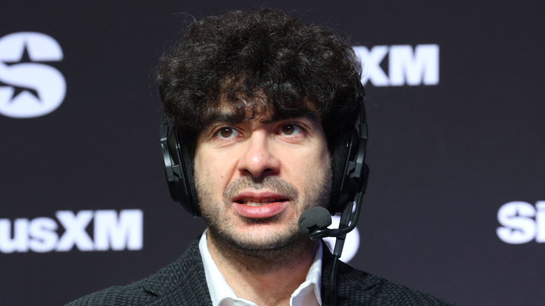 Tony Khan speaking into a headset