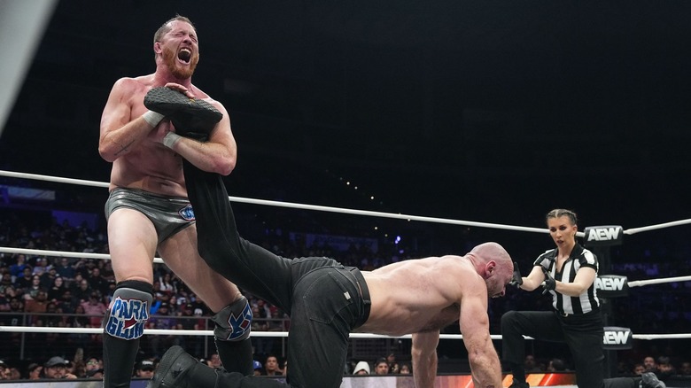 Kyle O'Reilly holds Jon Moxley in an ankle lock