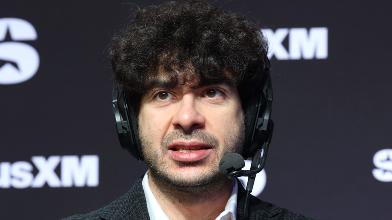 Tony Khan looking serious while wearing a headset