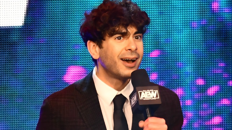 Tony Khan holding a mic