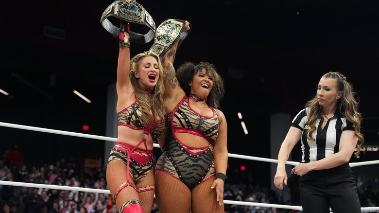 Babes of Wrath holding up their tag titles
