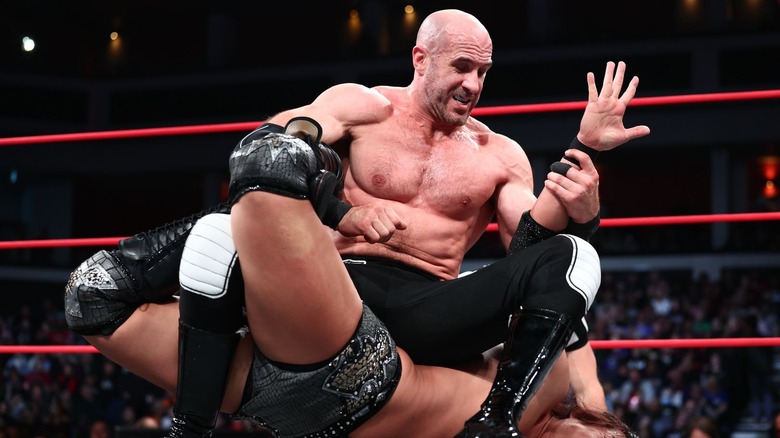 Claudio Castagnoli tying up Takeshita