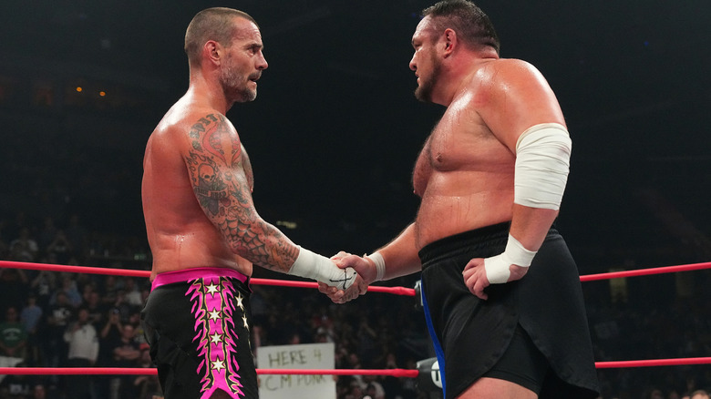 CM Punk shakes hands with Samoa Joe