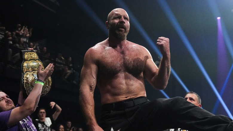Jon Moxley standing over the barricade