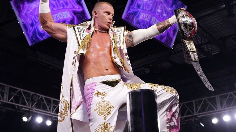 Kyle Fletcher holds up his TNT title